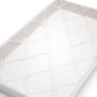 White ceramic guest towel tray with raised geometric grid texture, close-up