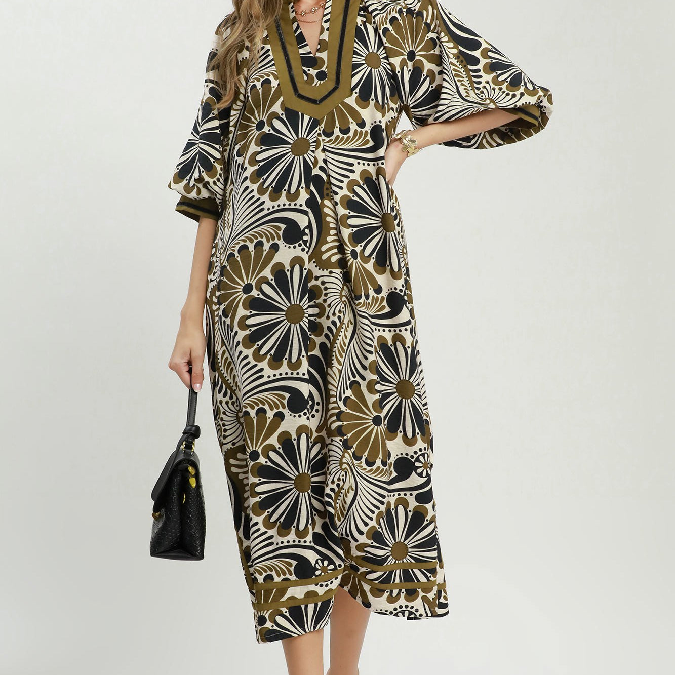 Woman wearing a patterned dress with a white background