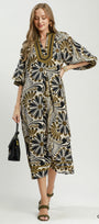 Woman wearing a patterned dress with a white background
