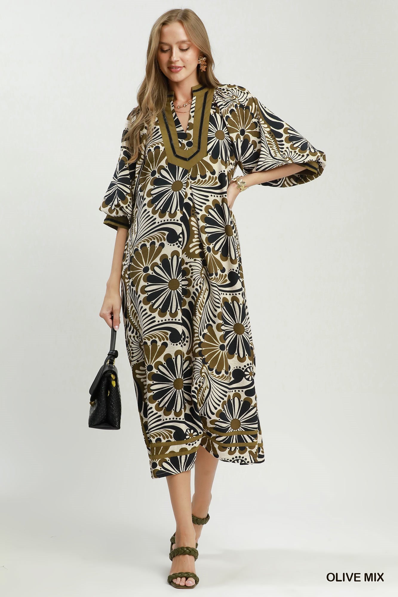 Woman wearing a patterned dress with a white background