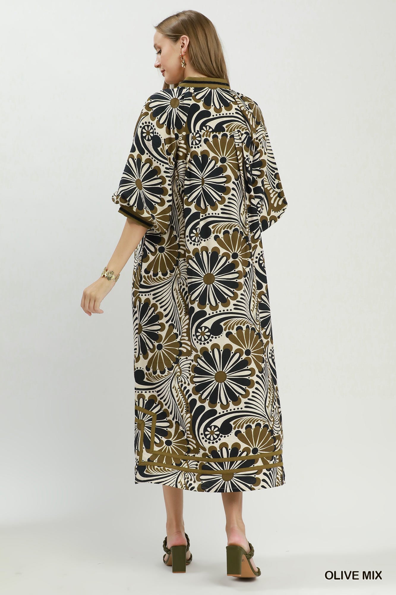 Woman wearing a patterned dress on a white background