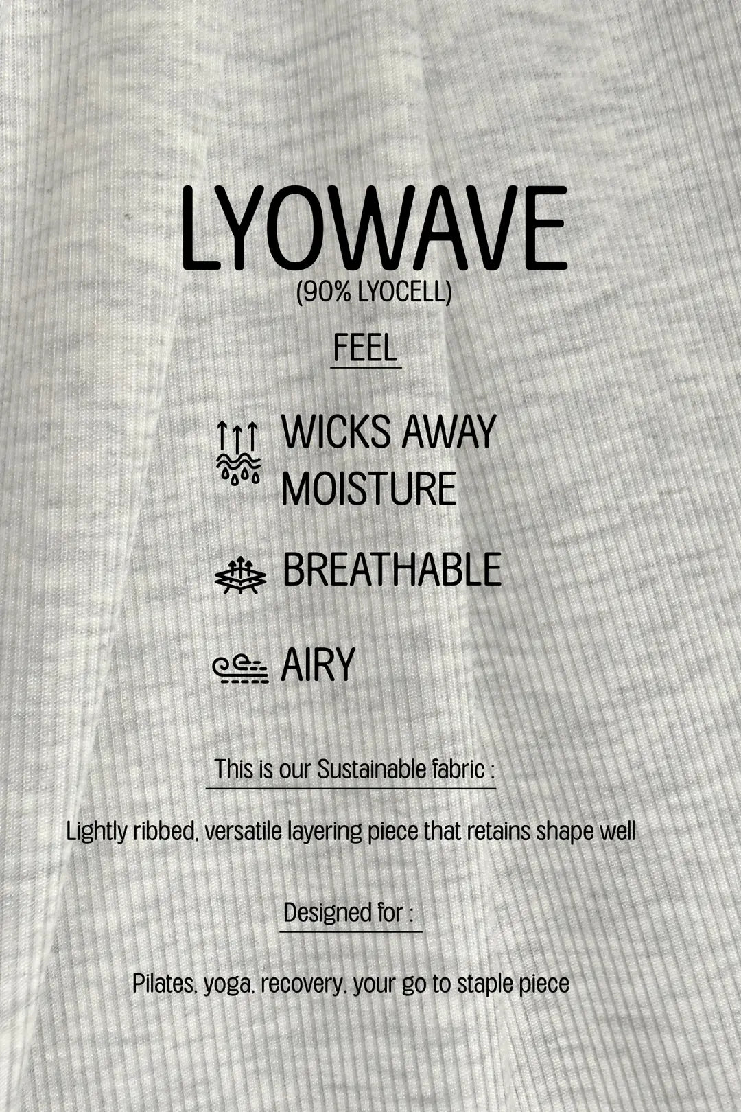 A close-up of light gray ribbed fabric with black printed text describing LYOWAVE material and product features, including 'WICKS AWAY MOISTURE', 'BREATHABLE', and 'AIRY'.