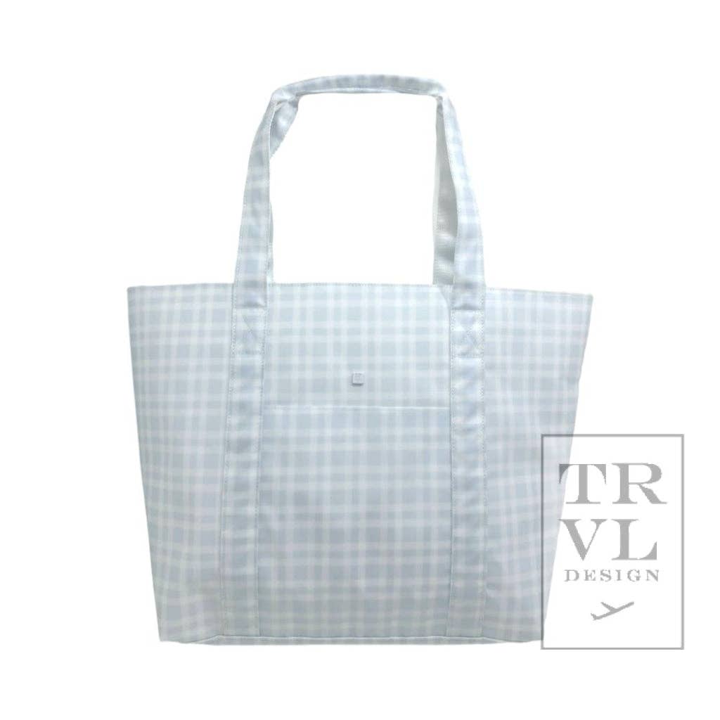 blue tote bag with grid pattern on a white background, featuring the TRVL Design logo.