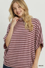 A woman wearing a mauve and white striped turtleneck top with wide batwing sleeves, shown against a light gray studio background. The word 'MAUVE' appears in the bottom right corner.