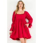 Woman wearing a red dress with puffed sleeves on a white background