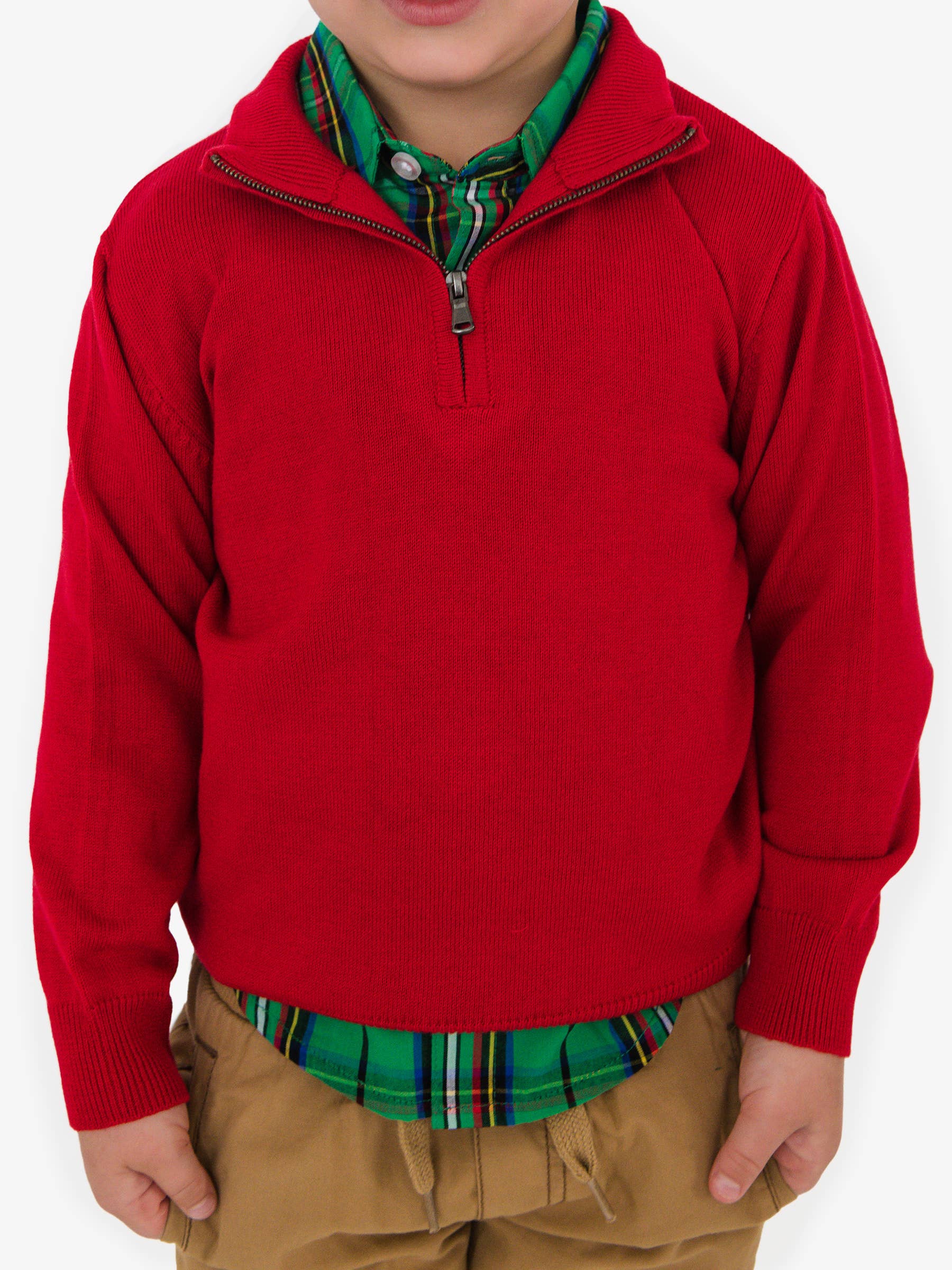 Child wearing a red sweater over a plaid shirt on a white background