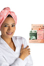 Woman wearing a pink towel with a box of Plot Twist products on a white background