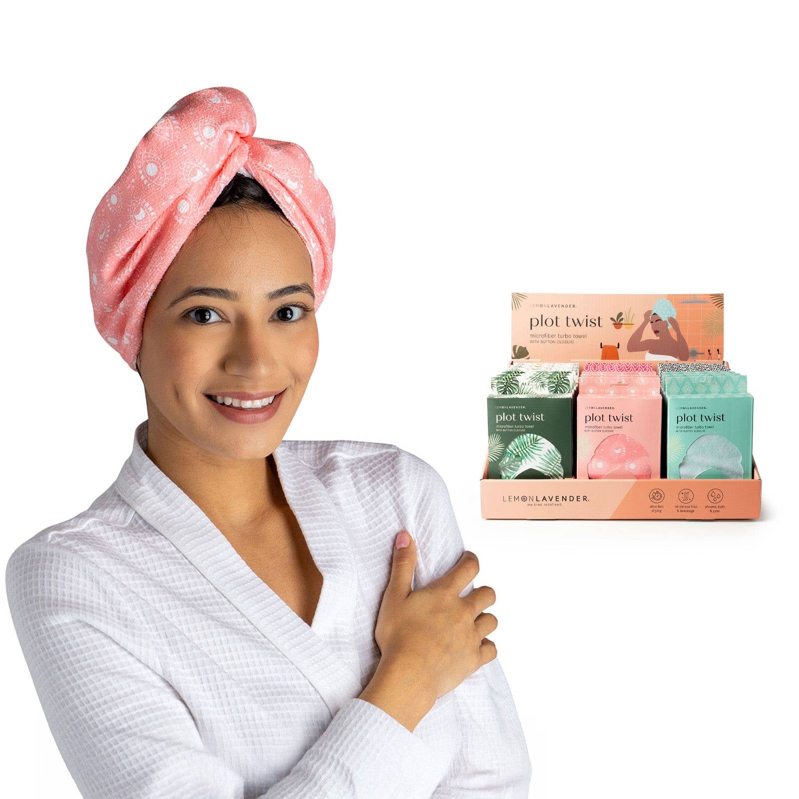 Woman wearing a pink towel with a box of Plot Twist products on a white background