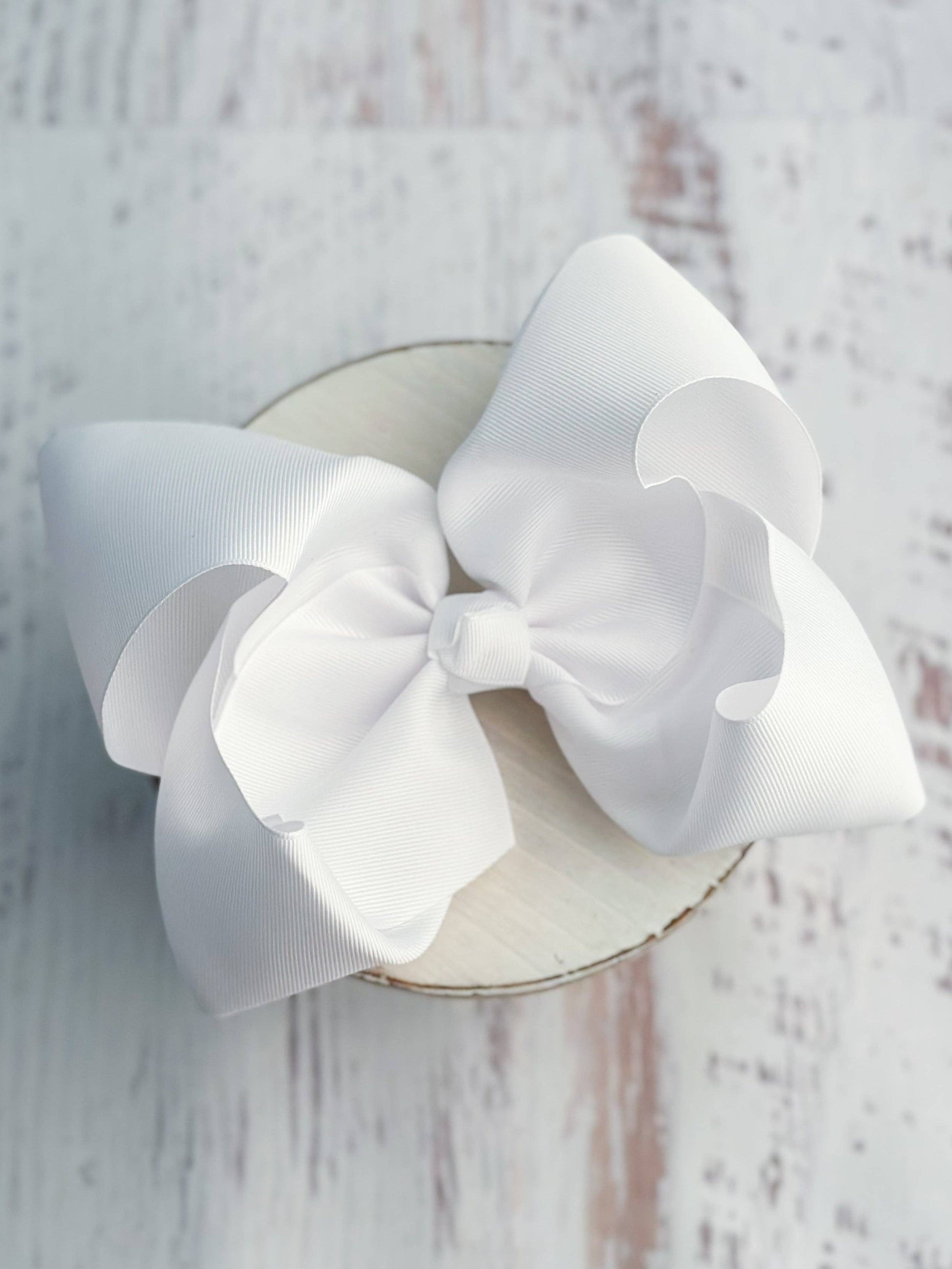 White bow on a wooden background