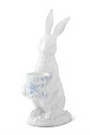 White ceramic rabbit figurine with a basket on a white background