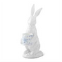 White ceramic rabbit figurine with a basket on a white background