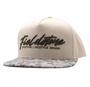 Beige cap with 'Fieldstone' branding on a white background