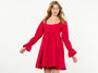 Woman wearing a red dress with long sleeves on a white background