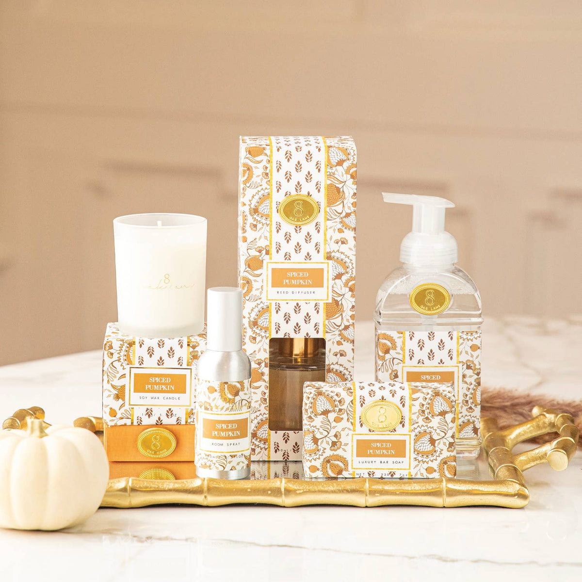 Spiced Pumpkin room spray bottle with pump, gold label, on a display table