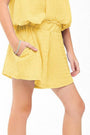 Yellow dress worn by a person on a white background