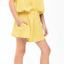 Yellow dress worn by a person on a white background