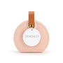 Round pink leather tag with a brown strap and gold accent on a white background