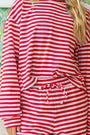 Red-and-white striped long-sleeve top with round neckline and gathered waist