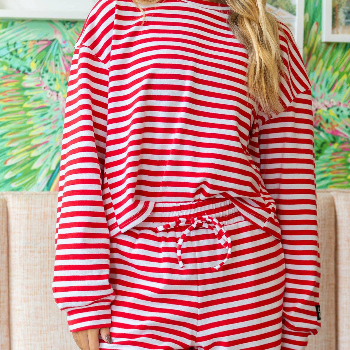 Red-and-white striped long-sleeve top with round neckline and gathered waist