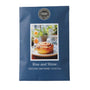 A blue scented candle packet from the brand House of Match Candle Company, featuring a photo of a cinnamon roll on the front and the scent name 'Rise and Shine'.