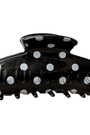 Black hair clip with white polka dots on a white background