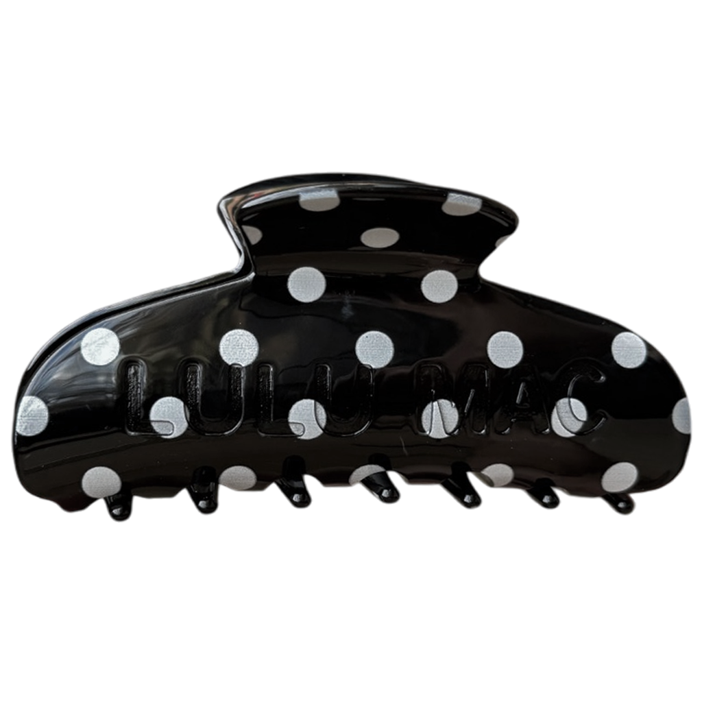 Black hair clip with white polka dots on a white background