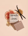 Kit'sch Warm Sugar Body Wash Bar with grapefruit, vanilla bean, and brown sugar on a beige background