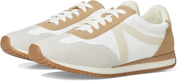 Pair of beige and white sneakers with brown soles on a white background