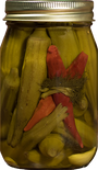 Jar of pickled vegetables with a red pepper inside