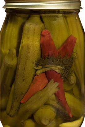 Jar of pickled vegetables with a red pepper inside