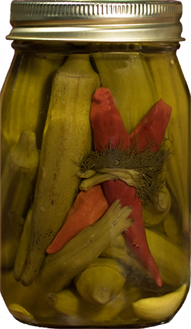 Jar of pickled vegetables with a red pepper inside