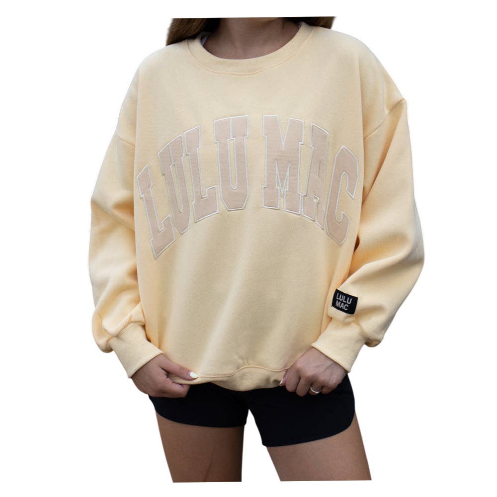 Pale yellow sweatshirt with 'LULU MAC' branding on a white background