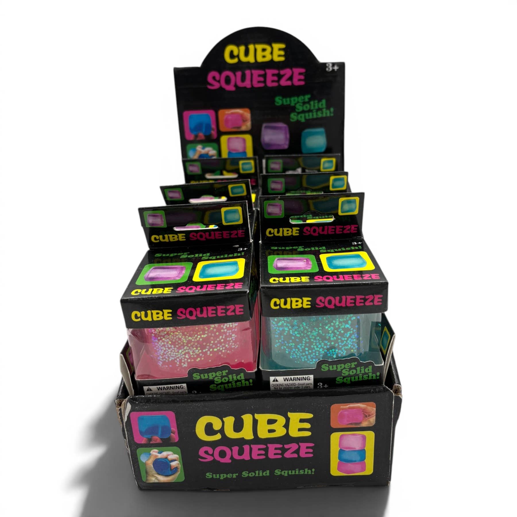 Display of Cube Squeeze toys with colorful packaging on a white background