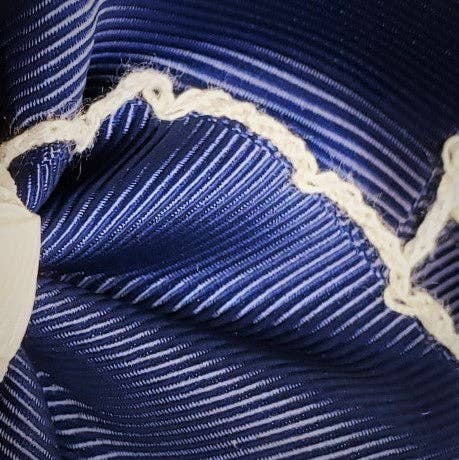 Close-up of a blue and white striped fabric with a textured pattern