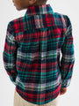 Person wearing a red, green, and white plaid shirt on a white background