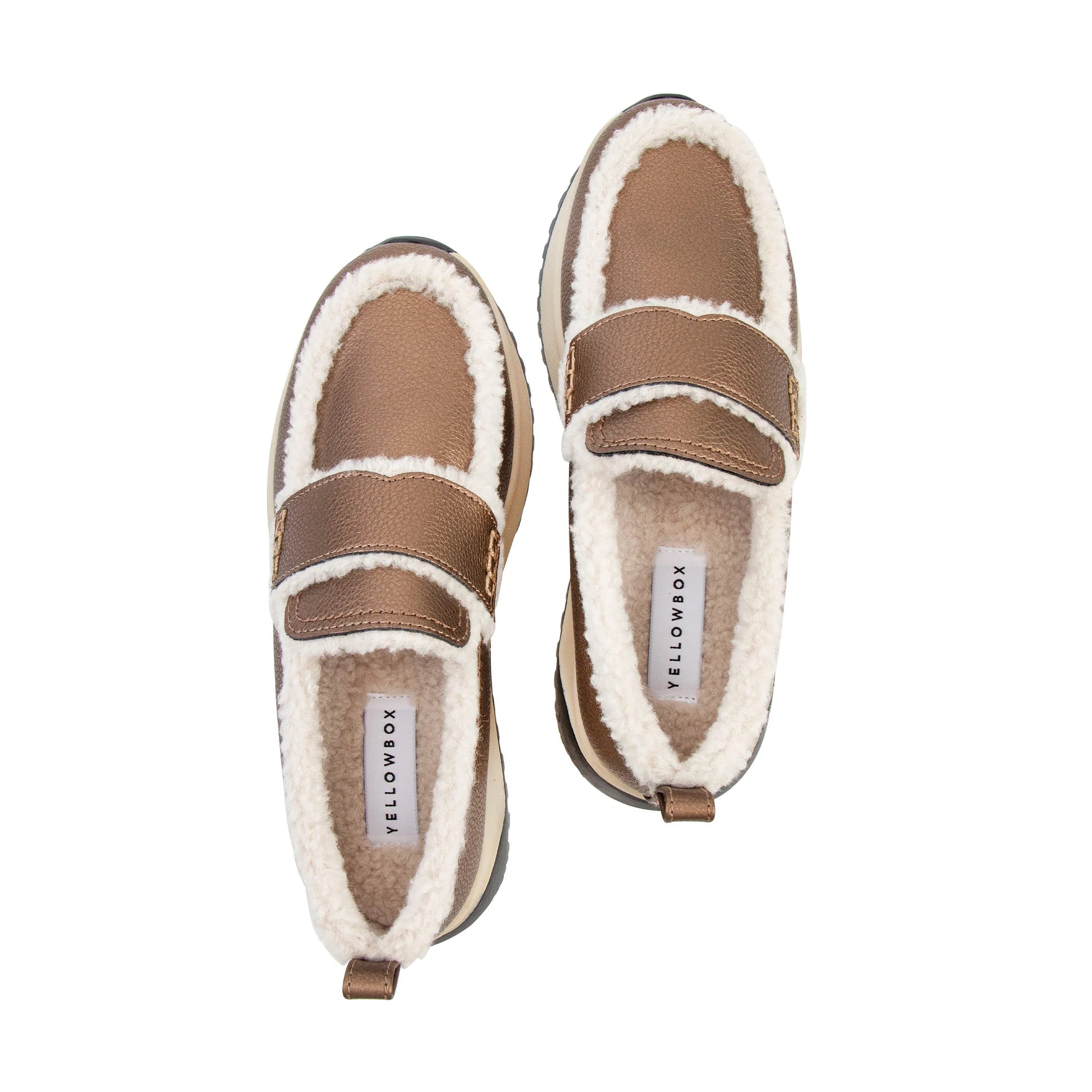 A pair of slip-on shearling shoes by YellowBox, shown from a top-down view on a solid white background. The shoes feature a brown faux-leather upper with a wide brown hook-and-loop strap, lined with soft white shearling fleece.