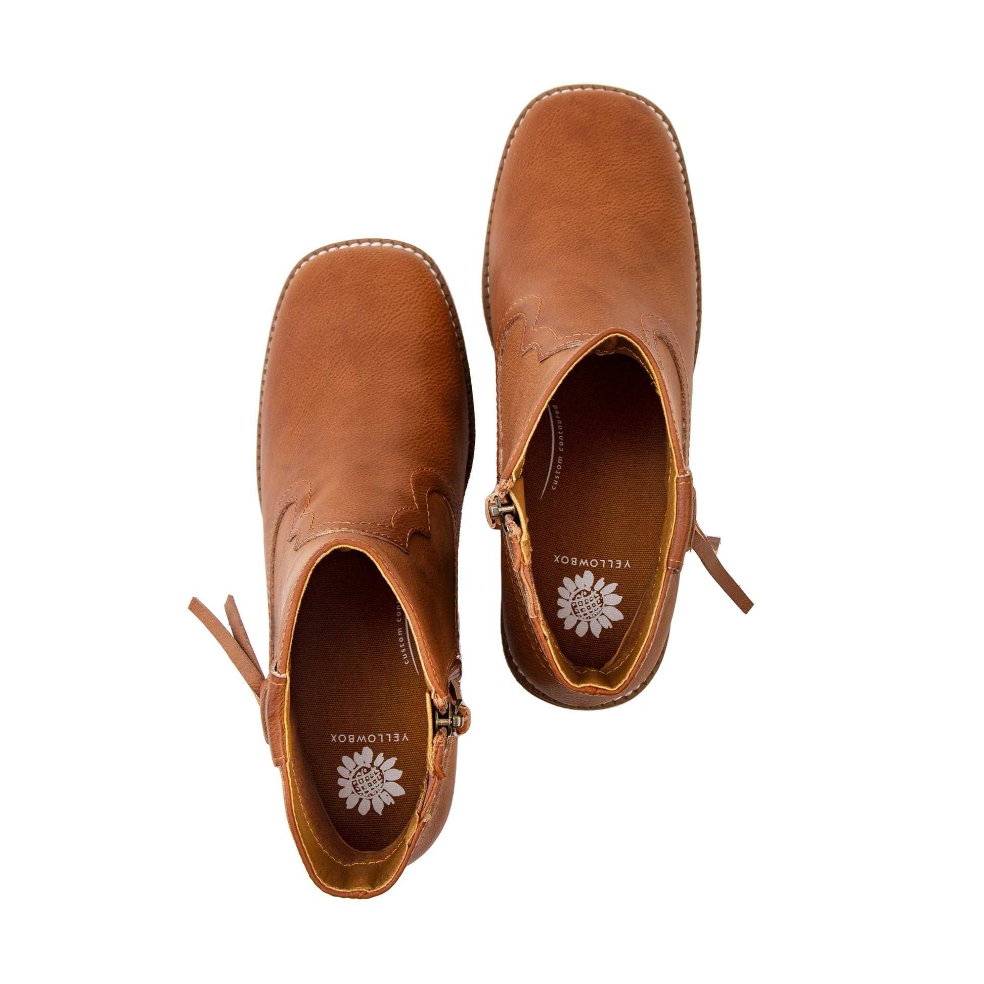 Pair of brown leather ankle boots on a white background