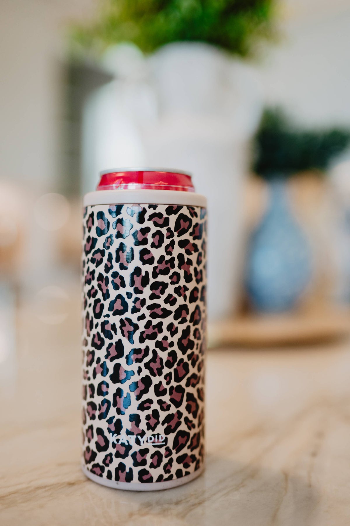 Slim can sleeve with brown leopard print, shown on a can