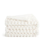 White knitted blanket on a white background