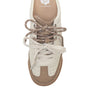 Top-down view of a low-top sneaker in off-white and tan, featuring metallic taupe laces and a tan rubber toe cap, with the Yellowbox logo printed on the inner lining.