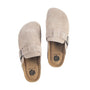 Pair of beige suede slippers with a brand logo on a white background