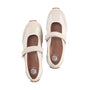 Pair of beige shoes with brown soles on a white background