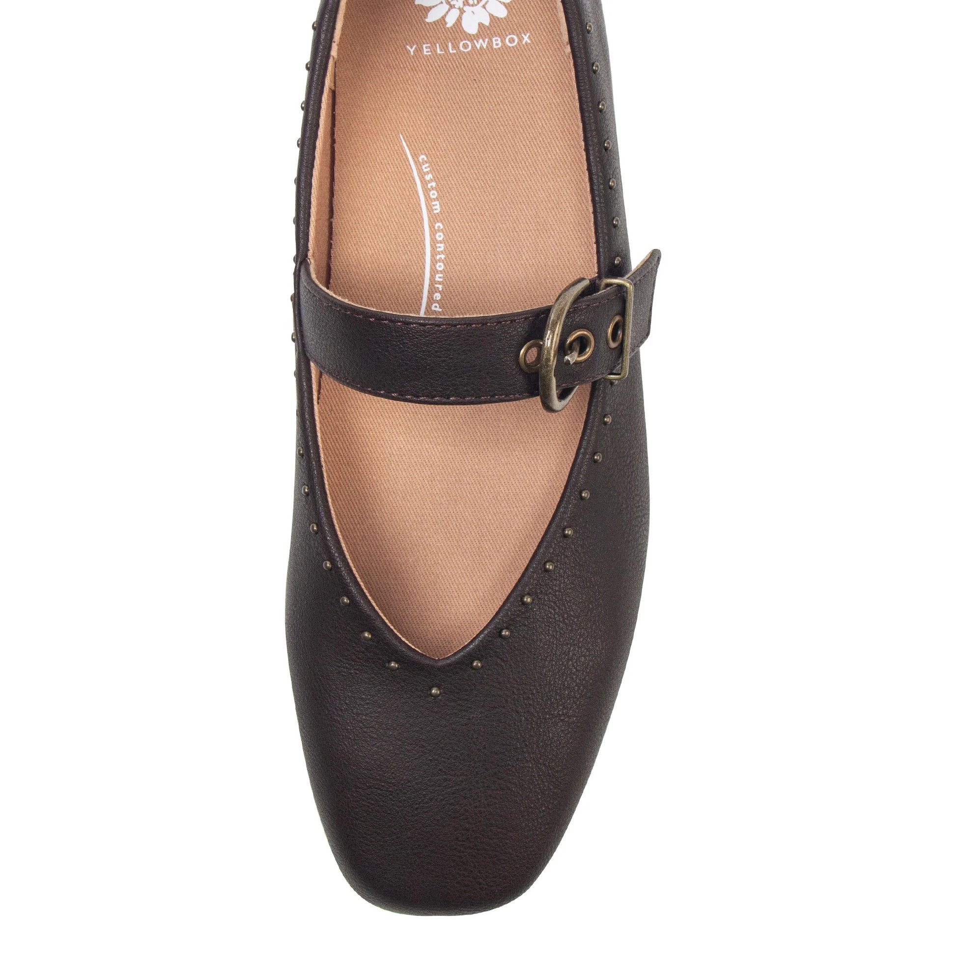 A dark brown leather Mary Jane flat shoe with a studded strap and a bronze buckle, shown from a top-down view on a white background.