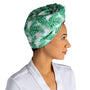 Woman wearing a green leaf-patterned headscarf on a white background