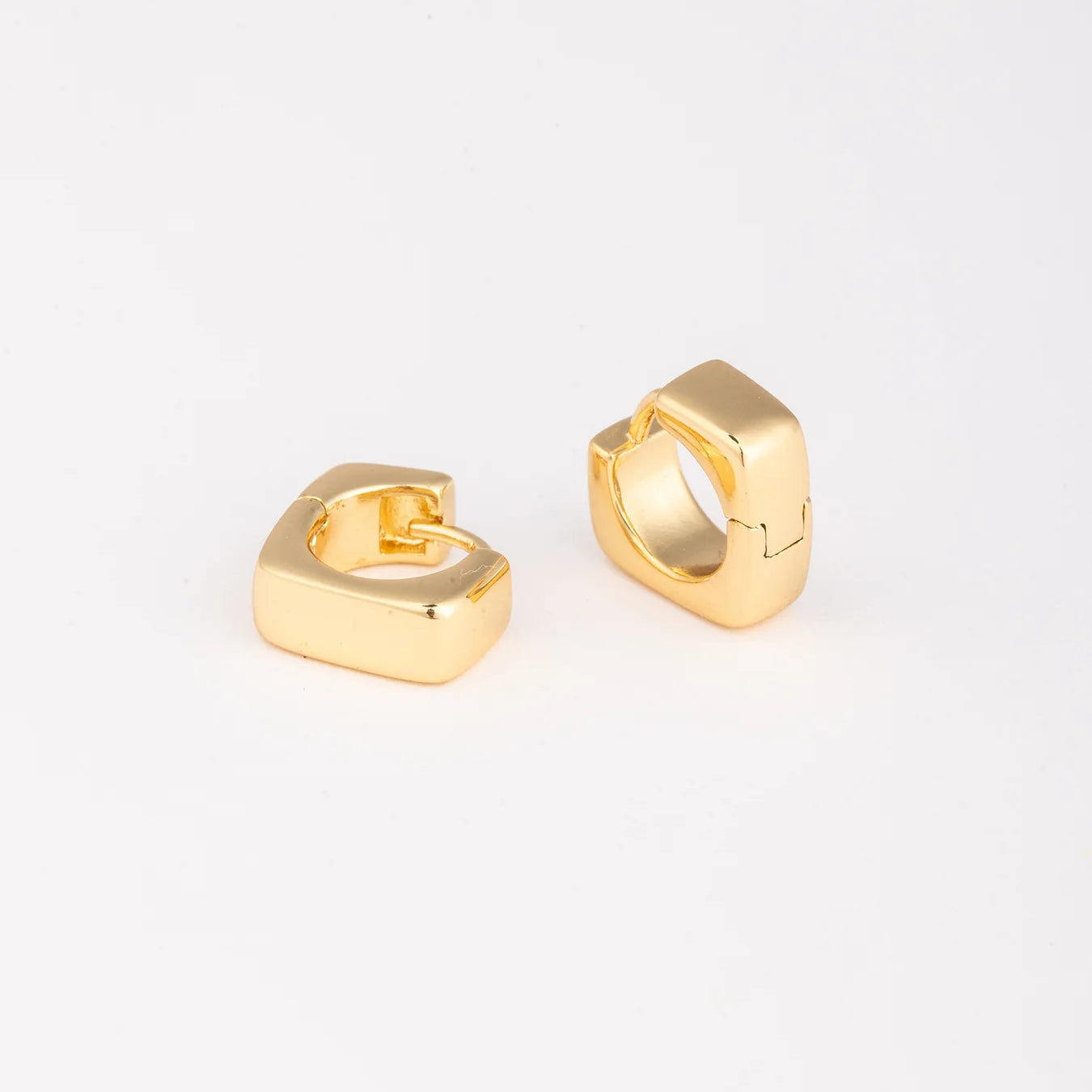 Gold hoop earrings on a white background