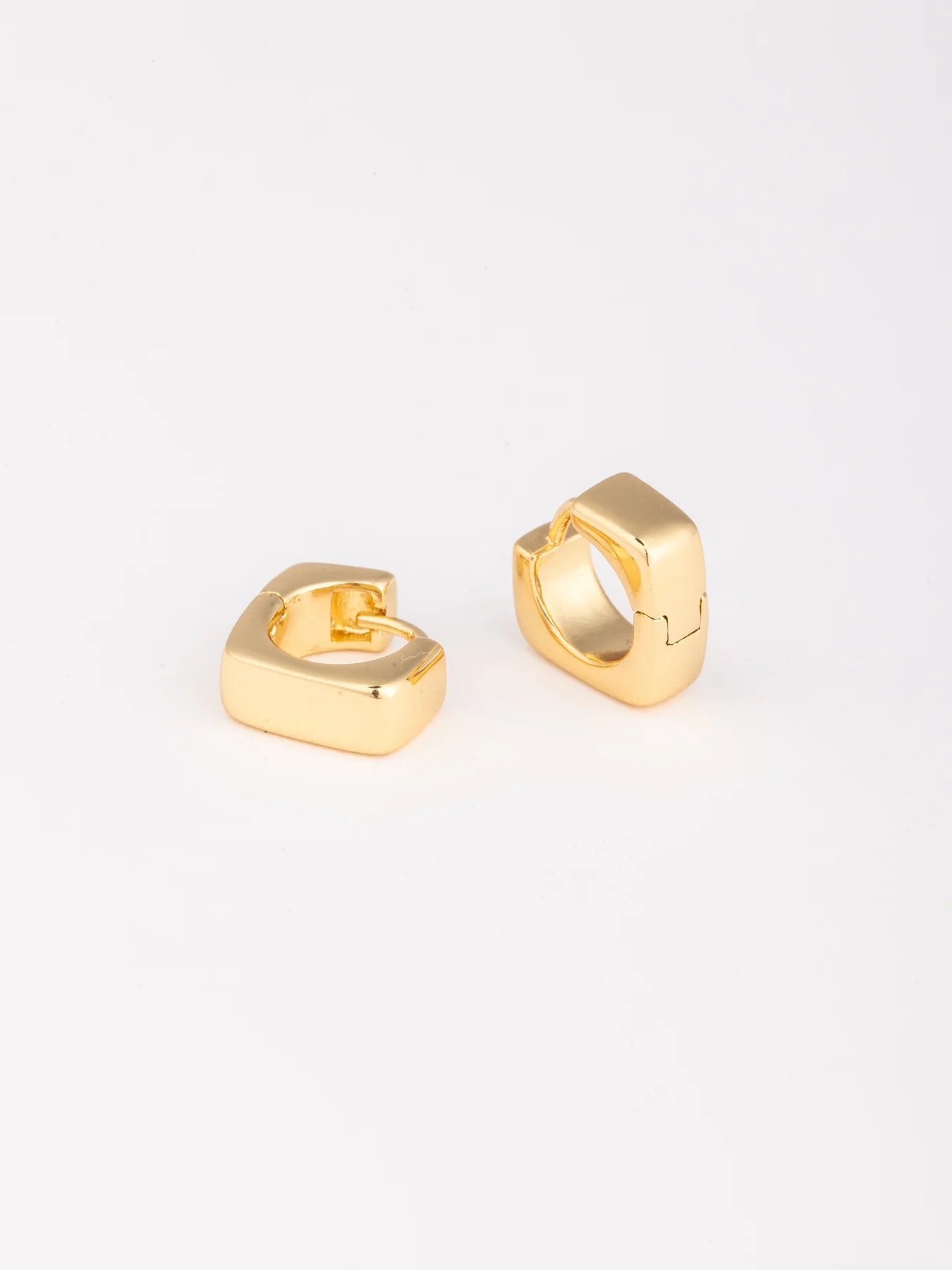 Gold hoop earrings on a white background