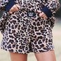 Leopard print shorts with navy cuffs and 'LULU MAC' label on a blurred background