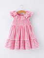 Pink and white striped dress on a hanger against a white background