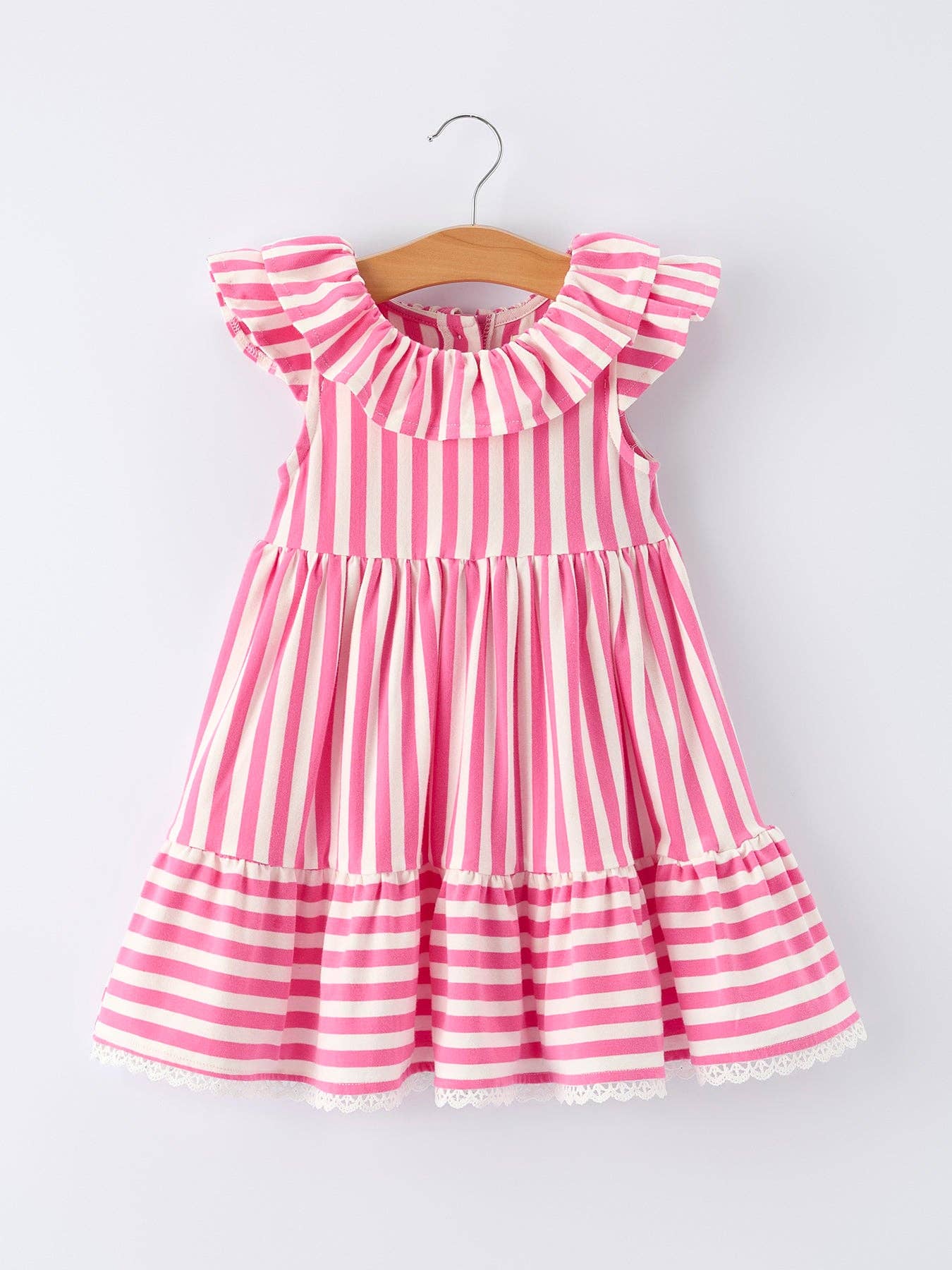 Pink and white striped dress on a hanger against a white background
