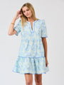 Woman wearing a light blue floral dress on a white background